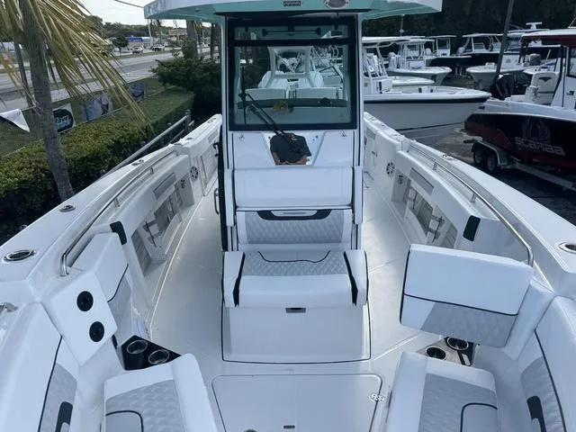 Slide: The Image of Suzuki dealership with various off-road vehicles parked outside. - 17