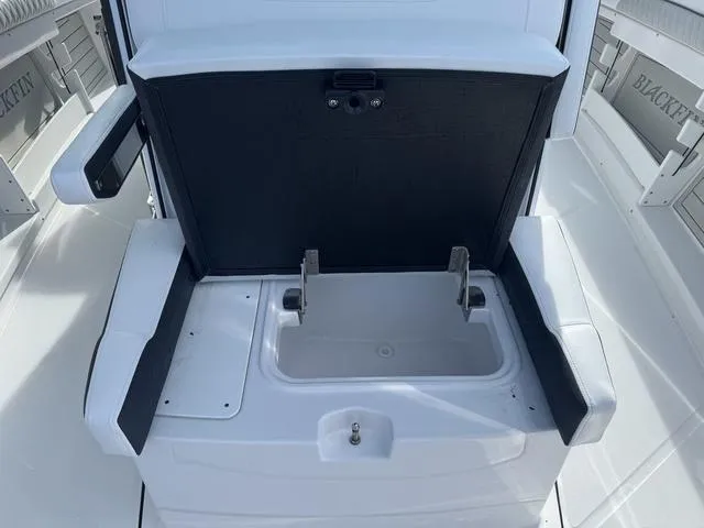 Slide: The Image of 2024 Blackfin 302CC model displayed in a showroom with a mannequin on a yellow jet ski. - 19