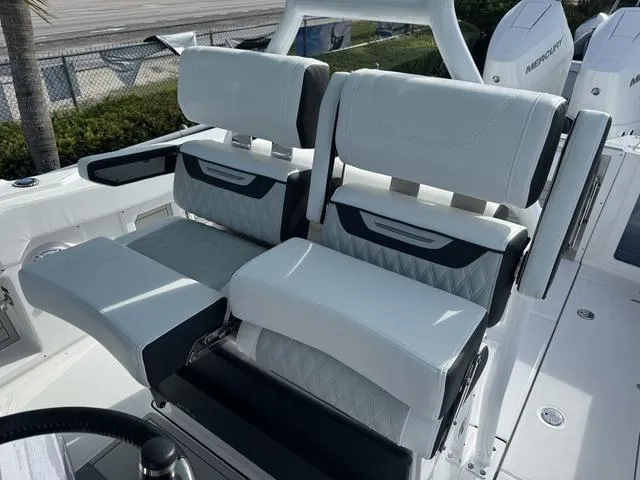 Slide: The Image of Showroom with various motorcycles, off-road vehicles, and a 2024 Blackfin 302CC boat. - 20