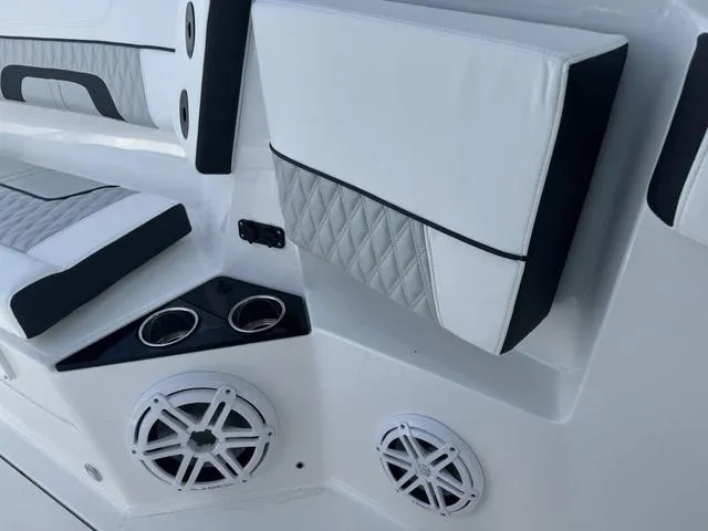 Slide: The Image of Outdoor dealership lot with boats, jet skis, and red golf carts under a blue sky. - 26