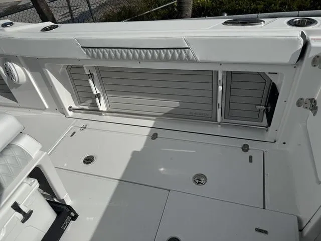 Slide: The Image of 2024 Blackfin 302CC boat interior with cooler and seating. - 7
