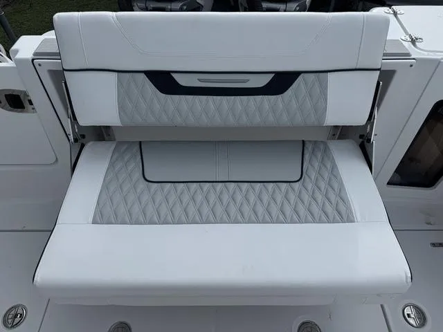 Slide: The Image of 2024 Blackfin 302CC boat dashboard with navigation screens and steering wheel. - 9