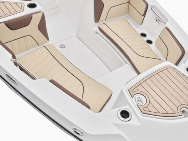 Slide: The Image of 2024 Yamaha Boats 222 FSH Sport interior with beige and brown seating. - 27