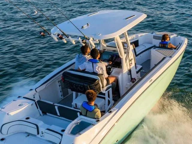 Slide: The Image of 2024 Yamaha Boats 255 FSH Sport E cruising with passengers on a sunny day. - 10