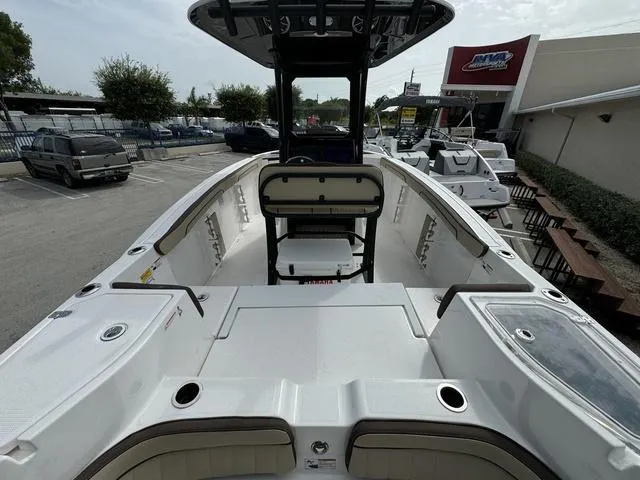 Slide: The Image of 2024 Yamaha Boats 255 FSH Sport E, center console view at dealership. - 4