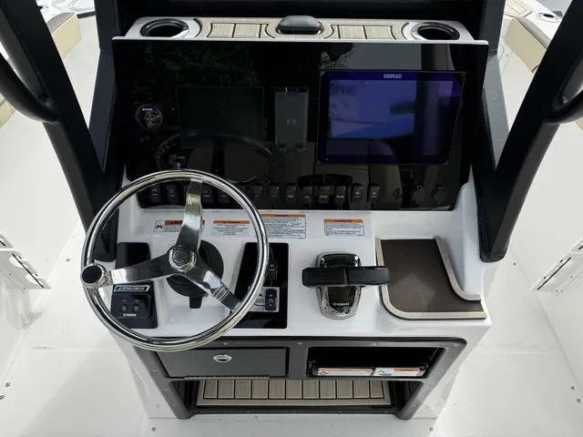 Slide: The Image of 2024 Yamaha Boats 255 FSH Sport E dashboard with steering wheel and control panel. - 6