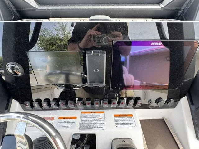 Slide: The Image of 2024 Yamaha Boats 255 FSH Sport E dashboard with dual displays and control switches. - 7