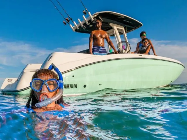 Slide: The Image of Family enjoying water activities near 2024 Yamaha Boats 252 FSH Sport. - 4