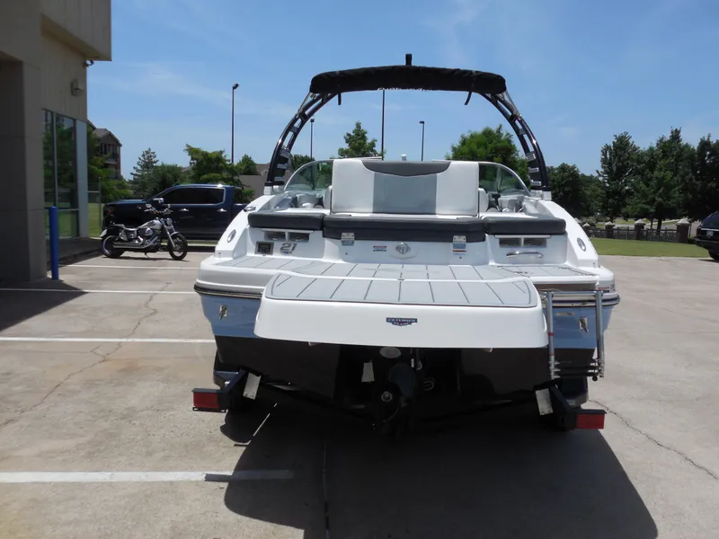 Slide: The Image of 2024 Chaparral 21 SSi boat rear view in a parking lot. - 4