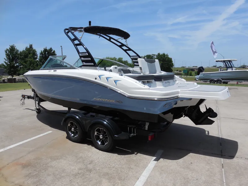 Slide: The Image of 2024 Chaparral 21 SSi boat on a trailer in a parking lot. - 5