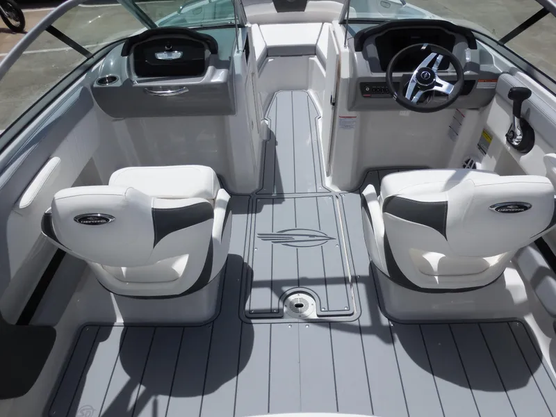 Slide: The Image of 2024 Chaparral 21 SSi boat interior with dual captain's chairs and modern dashboard. - 7