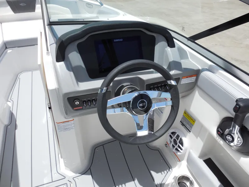 Slide: The Image of 2024 Chaparral 21 SSi boat dashboard with steering wheel and control panel. - 8