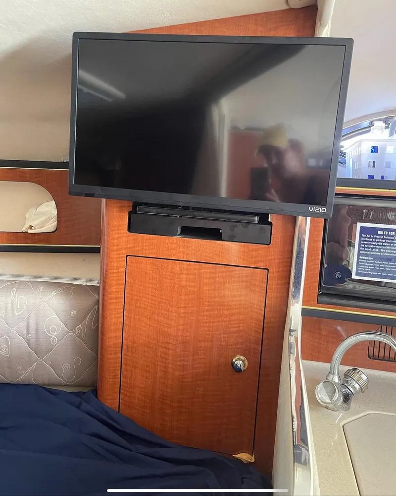 Slide: The Image of Flat-screen TV in the cabin of a 2002 Sea Ray 280 Sundancer boat. - 15