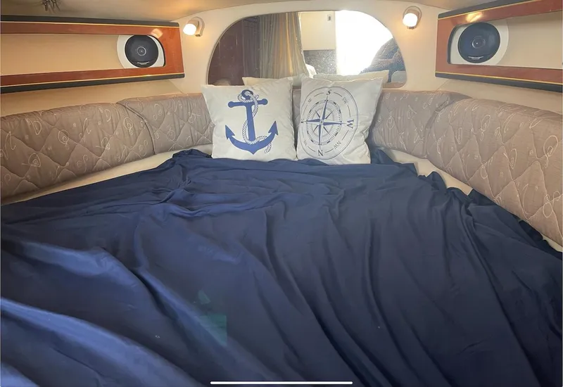 Slide: The Image of Cozy cabin interior of 2002 Sea Ray 280 Sundancer with nautical-themed pillows. - 16