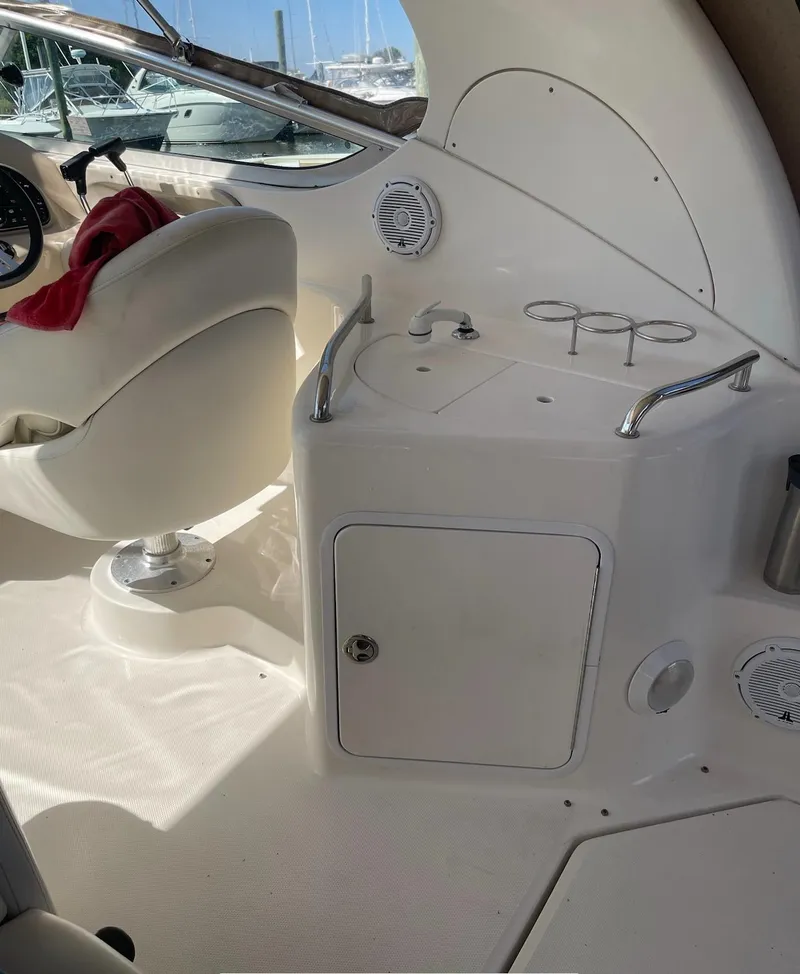 Slide: The Image of Interior of 2002 Sea Ray 280 Sundancer boat with helm and seating area. - 3