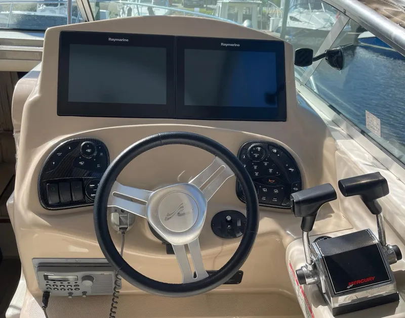 Slide: The Image of Steering console of a 2002 Sea Ray 280 Sundancer with dual Raymarine displays. - 4