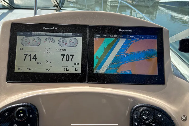 Slide: The Image of Dashboard of a 2002 Sea Ray 280 Sundancer with Raymarine displays. - 5