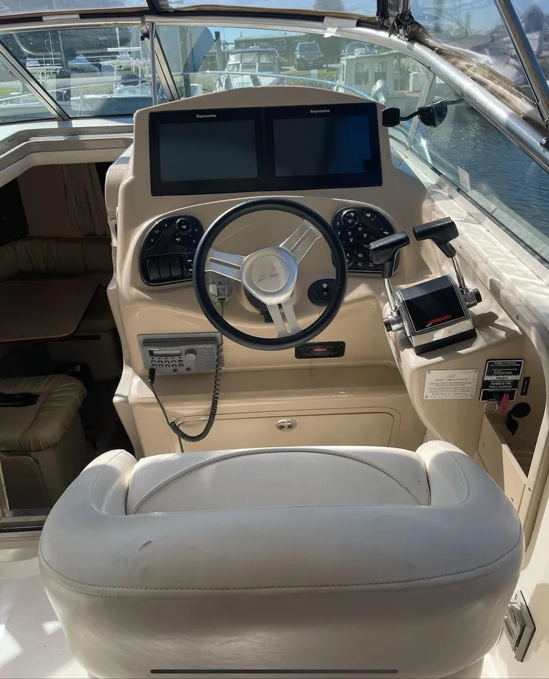 Slide: The Image of Helm of 2002 Sea Ray 280 Sundancer with steering wheel and navigation screens. - 6