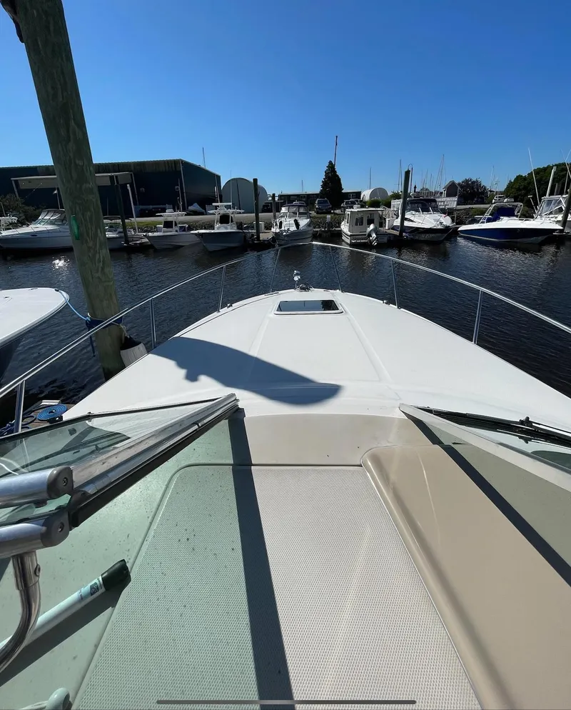 Slide: The Image of 2002 Sea Ray 280 Sundancer boat docked at a marina on a sunny day. - 7