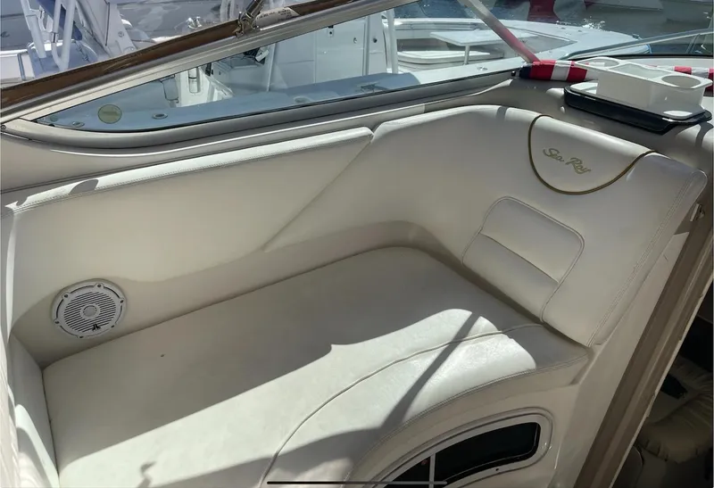 Slide: The Image of 2002 Sea Ray 280 Sundancer boat interior seating area with white upholstery. - 9