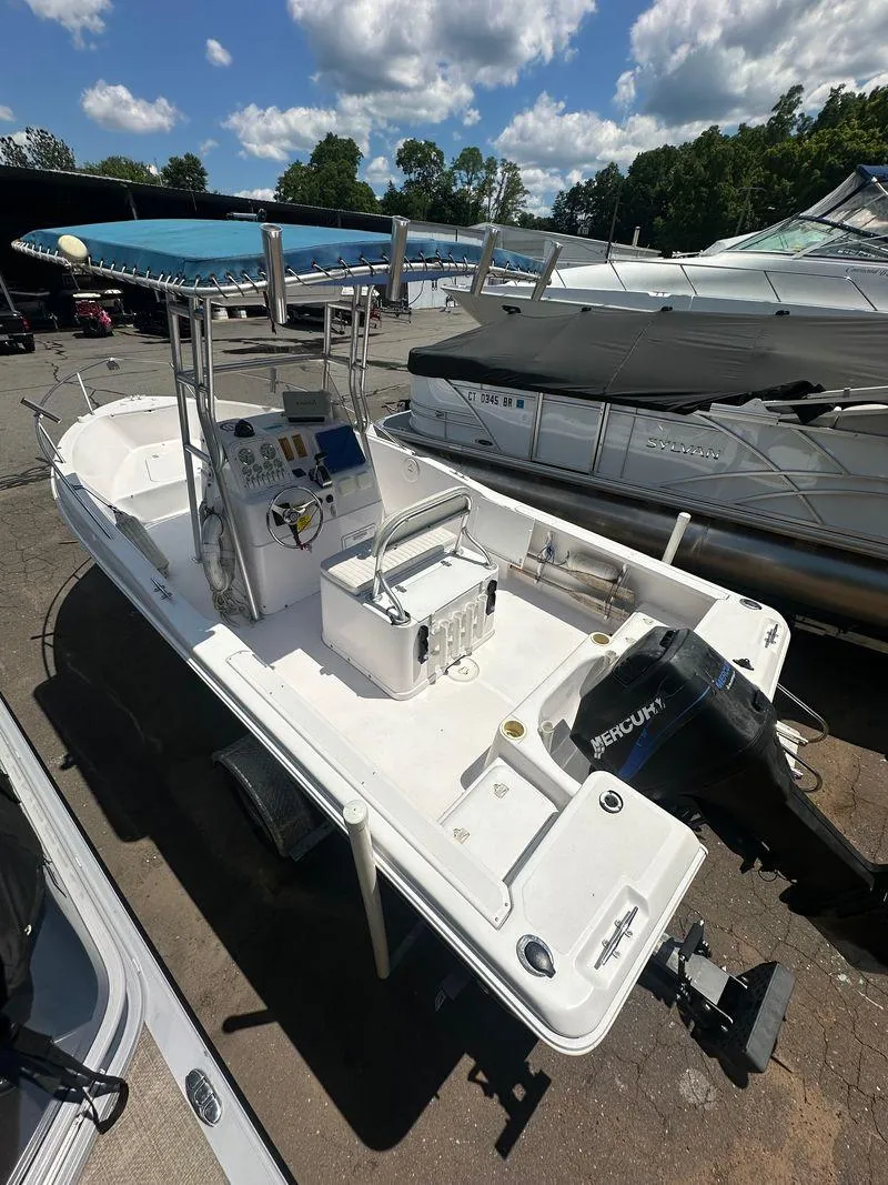 Slide: The Image of 2002 Pro-Line 20 Sport boat with Mercury outboard motor, docked at marina. - 10