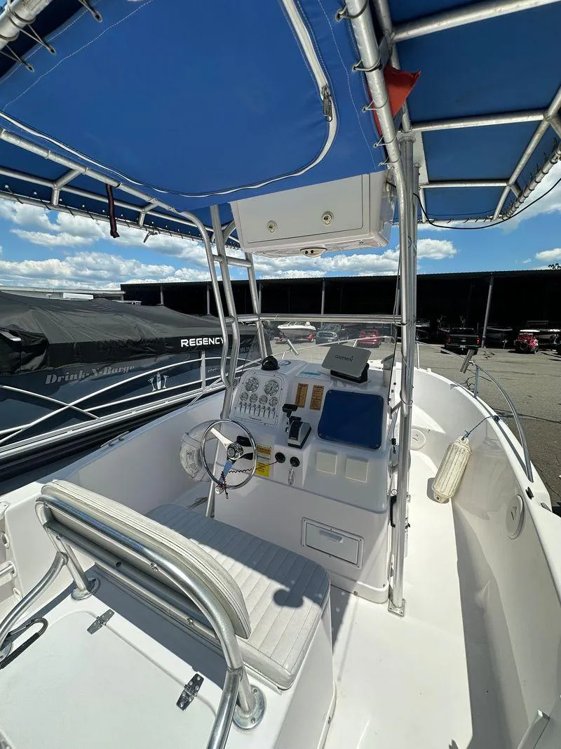 Slide: The Image of 2002 Pro-Line 20 Sport boat with blue canopy and well-equipped control console. - 12