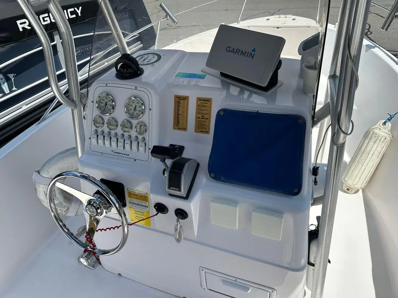 Slide: The Image of 2002 Pro-Line 20 Sport boat dashboard with Garmin GPS and control panel. - 16