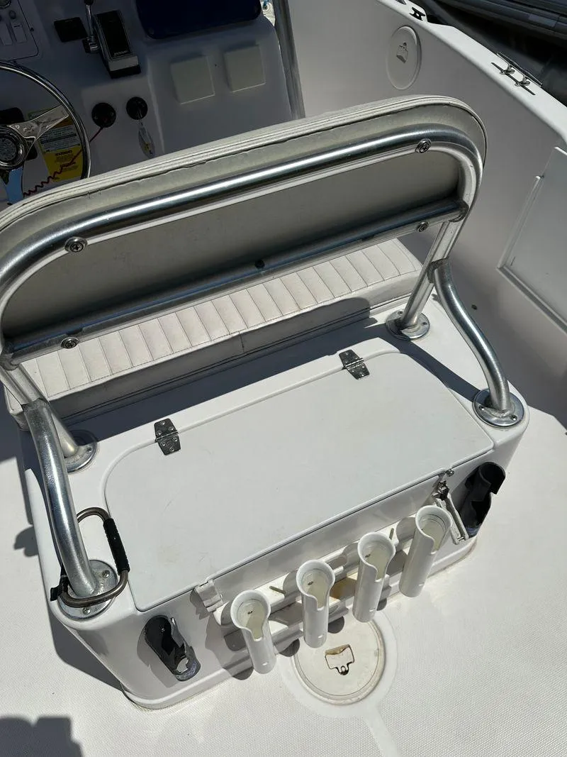 Slide: The Image of 2002 Pro-Line 20 Sport boat interior with rod holders and seating. - 18