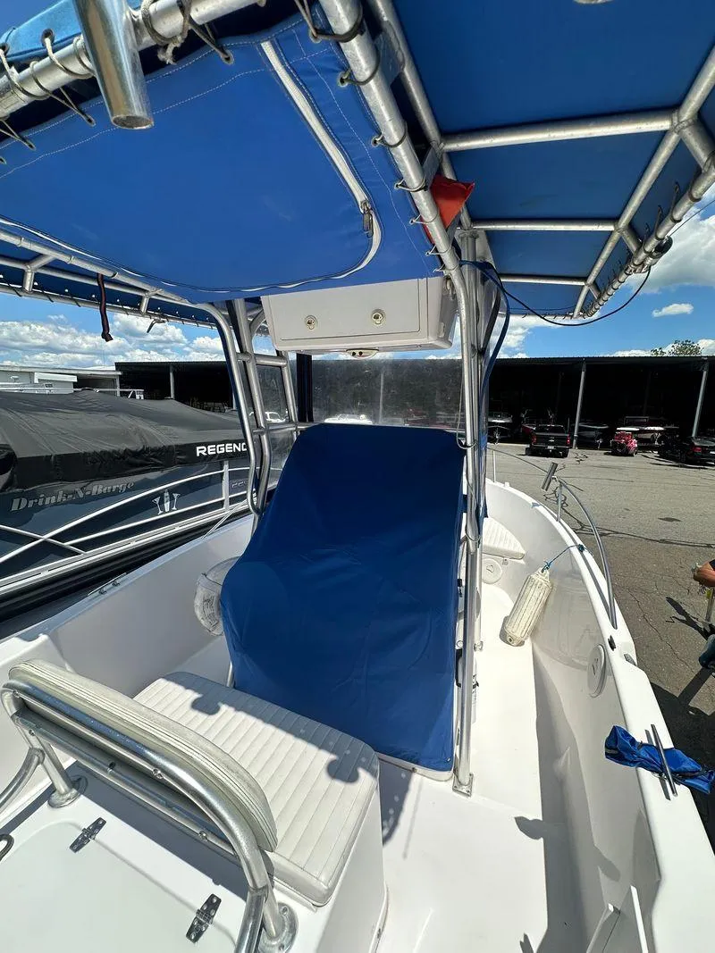 Slide: The Image of 2002 Pro-Line 20 Sport boat with blue canopy and seating. - 25