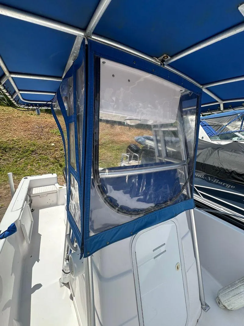 Slide: The Image of 2002 Pro-Line 20 Sport boat with blue canopy and enclosed helm. - 26