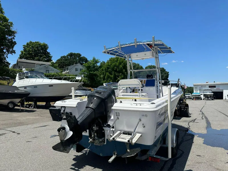 Slide: The Image of 2002 Pro-Line 20 Sport boat with outboard motor on trailer in marina. - 3