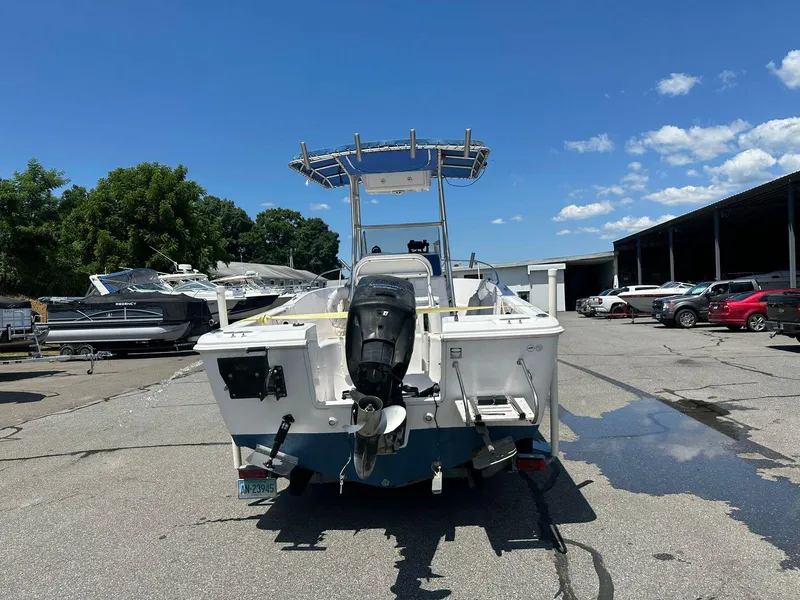 Slide: The Image of 2002 Pro-Line 20 Sport boat with outboard motor in a marina. - 4