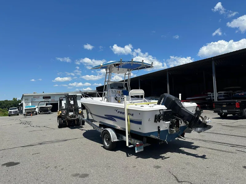 Slide: The Image of 2002 Pro-Line 20 Sport boat on trailer in outdoor storage area. - 6