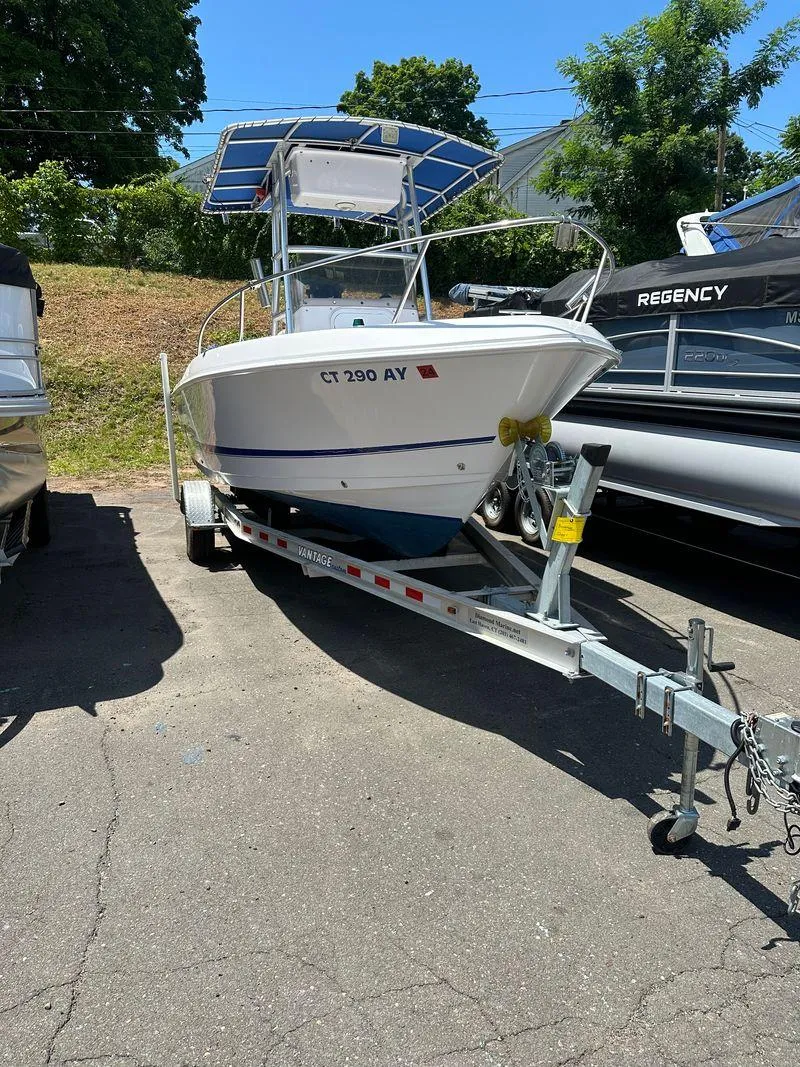 Slide: The Image of 2002 Pro-Line 20 Sport boat on a trailer in a parking lot. - 9