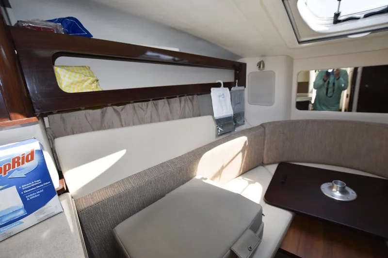 Slide: The Image of Interior cabin of a 2015 Sea Ray 260 Sundancer boat with seating and table. - 13