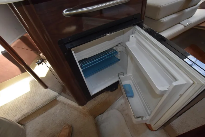 Slide: The Image of Open refrigerator inside 2015 Sea Ray 260 Sundancer boat cabin. - 16