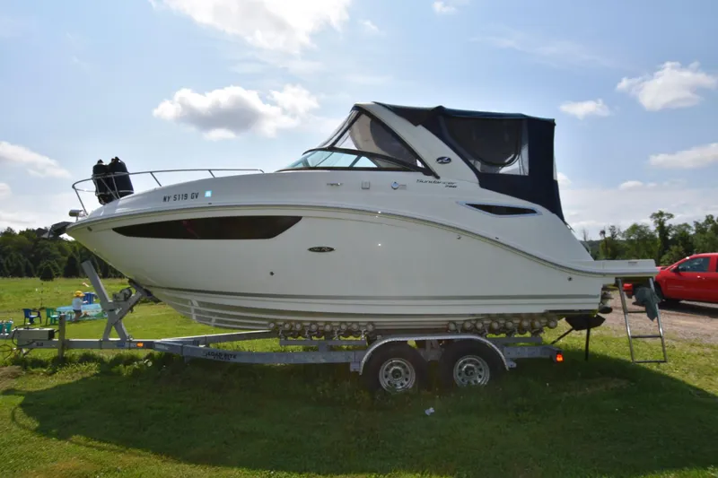 Slide: The Image of 2015 Sea Ray 260 Sundancer boat on a trailer in a grassy area. - 3