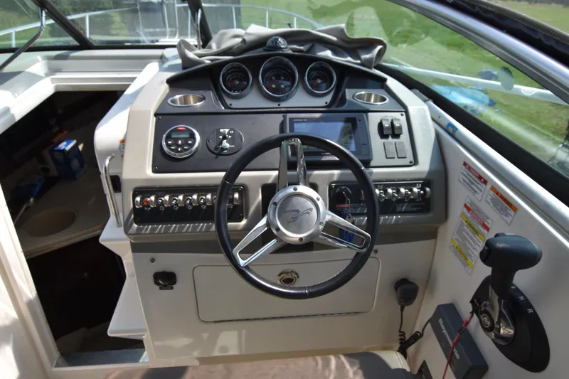 Slide: The Image of Helm of 2015 Sea Ray 260 Sundancer with steering wheel and control panel. - 7