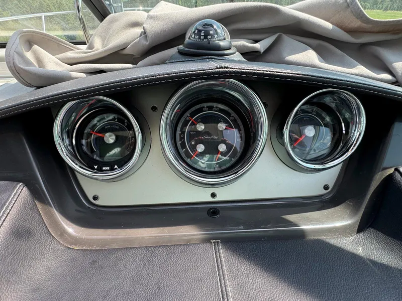 Slide: The Image of Dashboard of a 2015 Sea Ray 260 Sundancer boat with gauges and compass. - 9