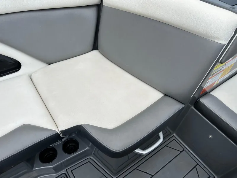 Slide: The Image of 2017 Tigé R21 boat interior seating with gray and white upholstery. - 12