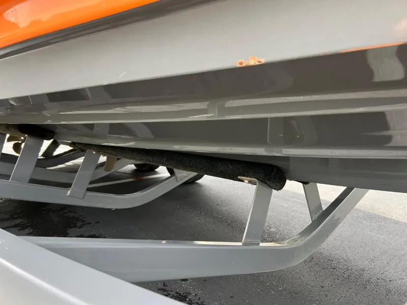 Slide: The Image of Close-up of the underside of a 2017 Tigé R21 boat on a trailer. - 19