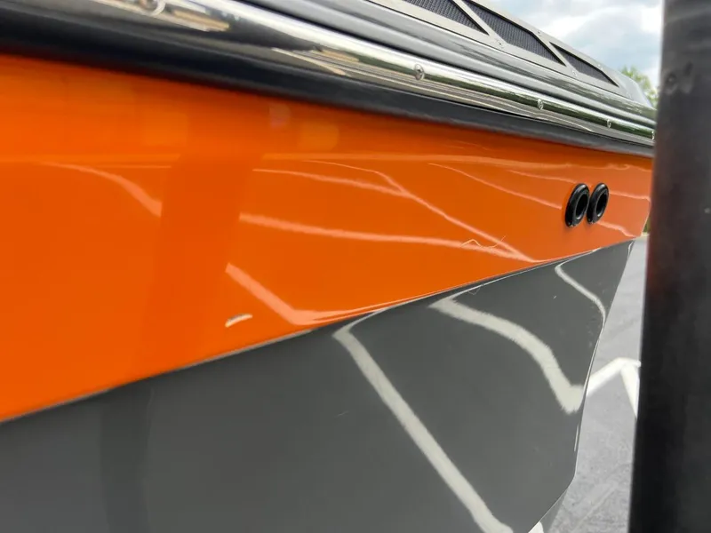 Slide: The Image of 2017 Tigé R21 boat with orange and gray exterior detailing. - 22
