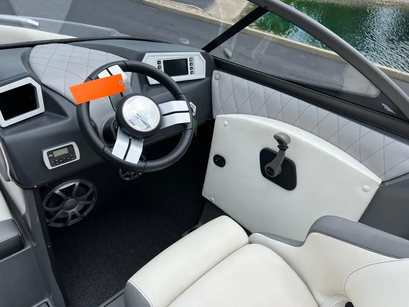 Slide: The Image of 2017 Tigé R21 boat interior with steering wheel and dashboard. - 9