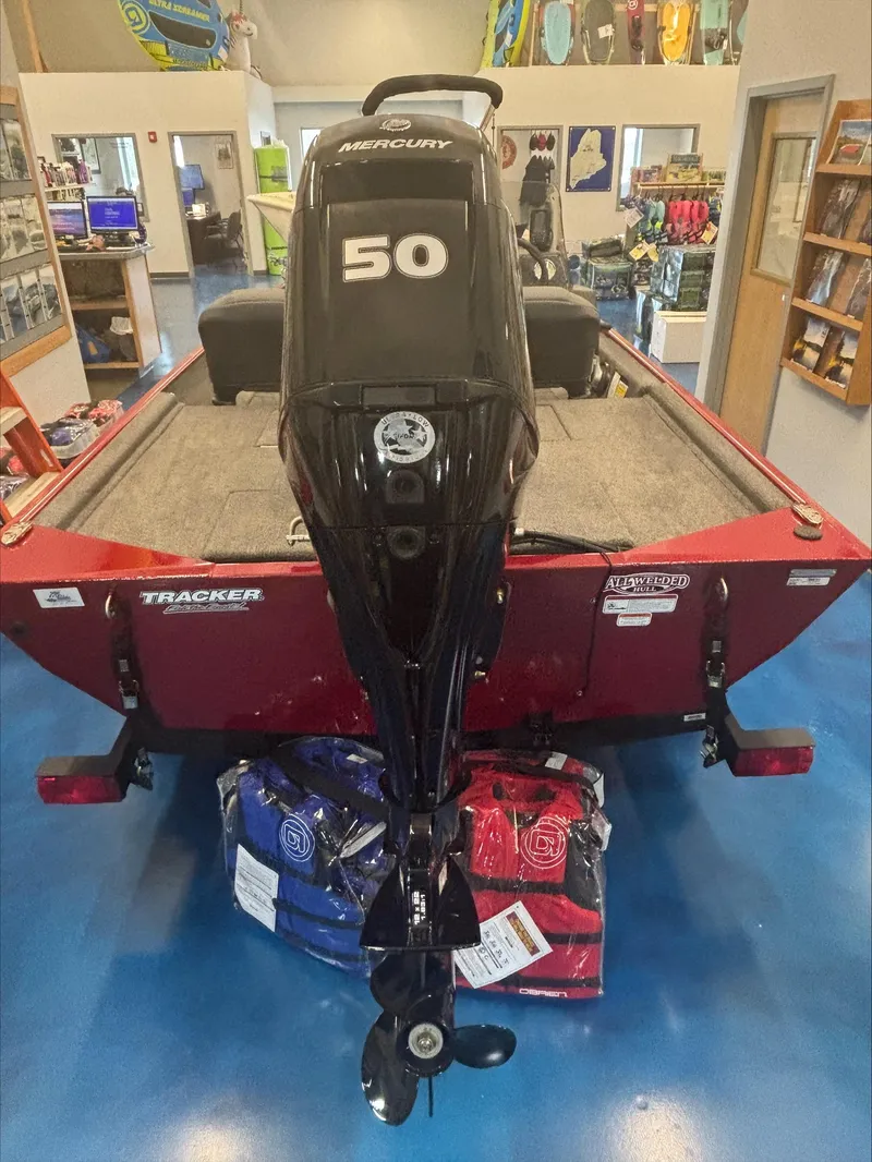 Slide: The Image of 2024 Tracker BT CLASSIC XL boat with Mercury 50 engine, displayed indoors. - 2