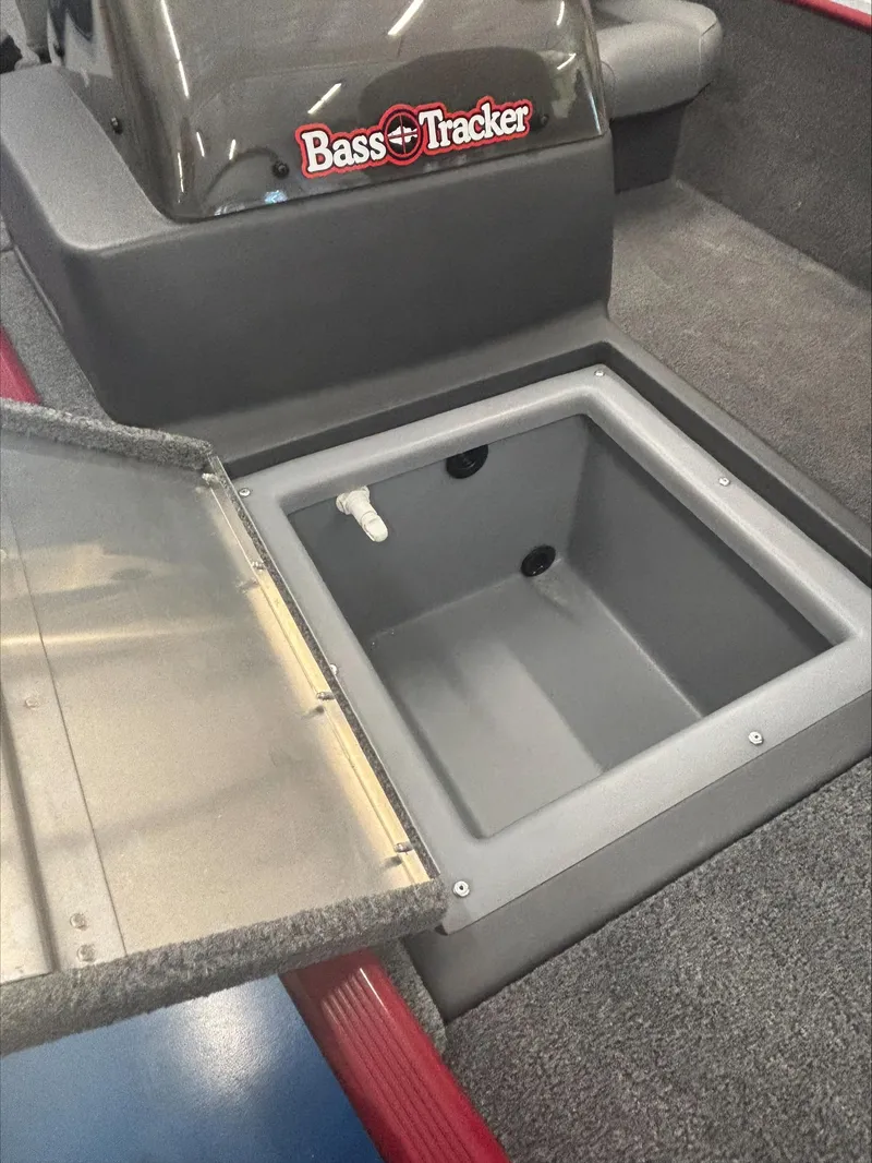 Slide: The Image of 2024 Tracker BT CLASSIC XL boat storage compartment with open lid, featuring Bass Tracker branding. - 5
