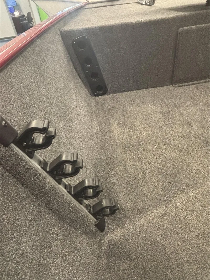 Slide: The Image of 2024 Tracker BT CLASSIC XL boat interior with rod holders and carpeted flooring. - 6