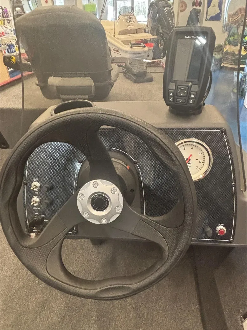 Slide: The Image of 2024 Tracker BT CLASSIC XL dashboard with steering wheel and Garmin device. - 8