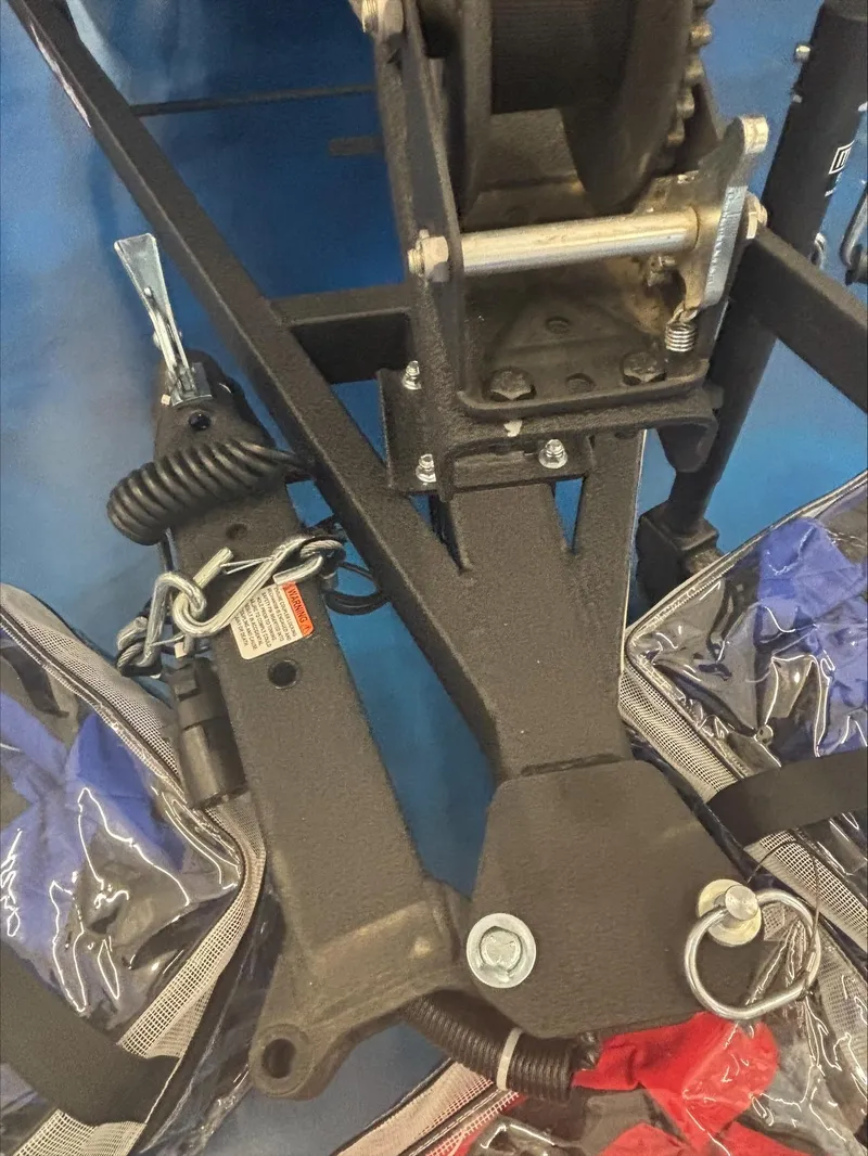 Slide: The Image of 2024 Tracker BT CLASSIC XL trailer hitch with safety chains and winch mechanism. - 9