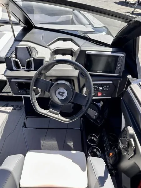 Slide: The Image of 2024 Axis A225 boat dashboard with steering wheel and control panel. - 11