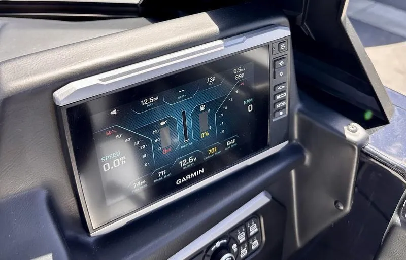Slide: The Image of 2024 Axis A225 dashboard with Garmin display showing speed, RPM, and voltage. - 12